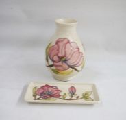 Moorcroft pottery vase, baluster-shaped with slip trails magnolia decoration on a cream ground, 20cm