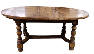 Stained elm extending dining table of revived 17th century-style, the oval top with extra leaf and