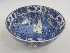 Probably Japanese porcelain bowl painted in blue and black, with group of figures in interior,