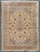 A Persian Kashan with central floral medallion and scrolling meandering foliate design contained