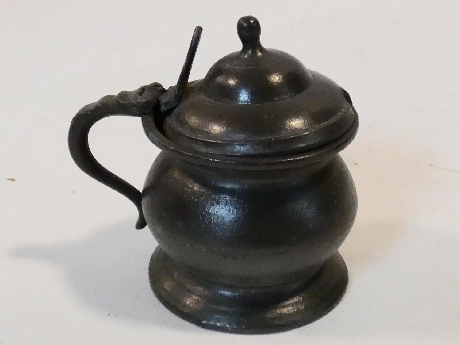 A collection of antique pewter items. Including plates, measures, pepper shaker, jug and tankards. - Image 21 of 27