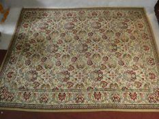 An Eastern style carpet with repeating floral pattern across the field within complementary borders.