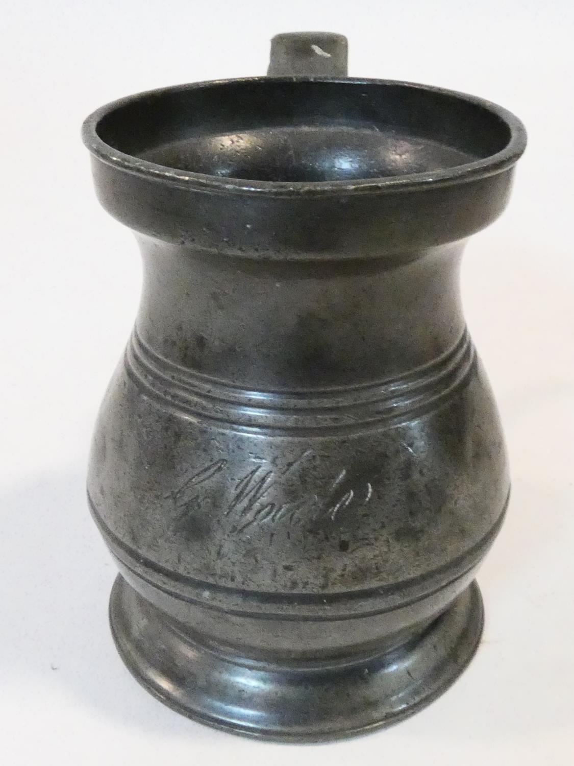 A collection of antique pewter items. Including plates, measures, pepper shaker, jug and tankards. - Image 11 of 27
