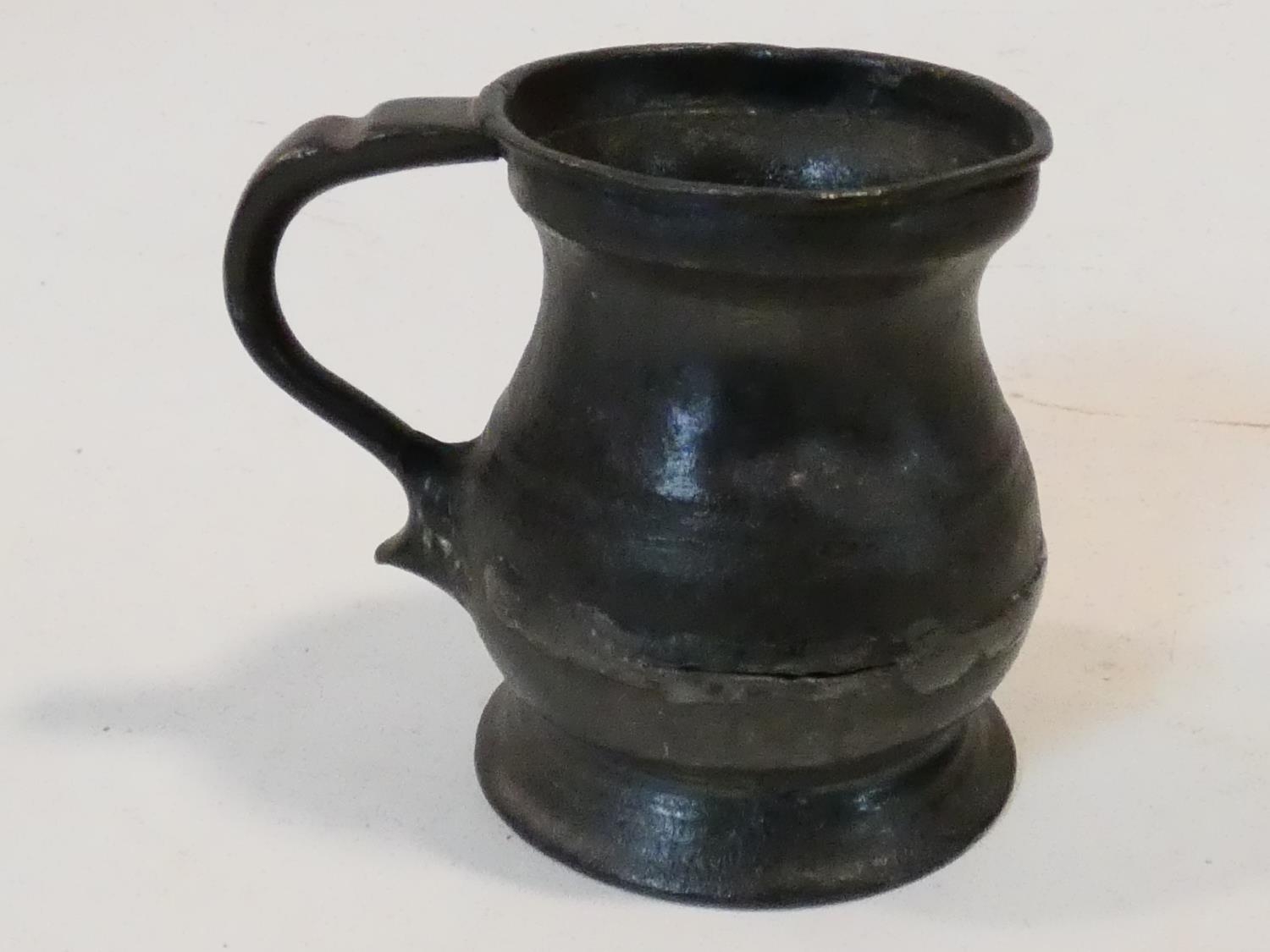 A collection of antique pewter items. Including plates, measures, pepper shaker, jug and tankards. - Image 18 of 27