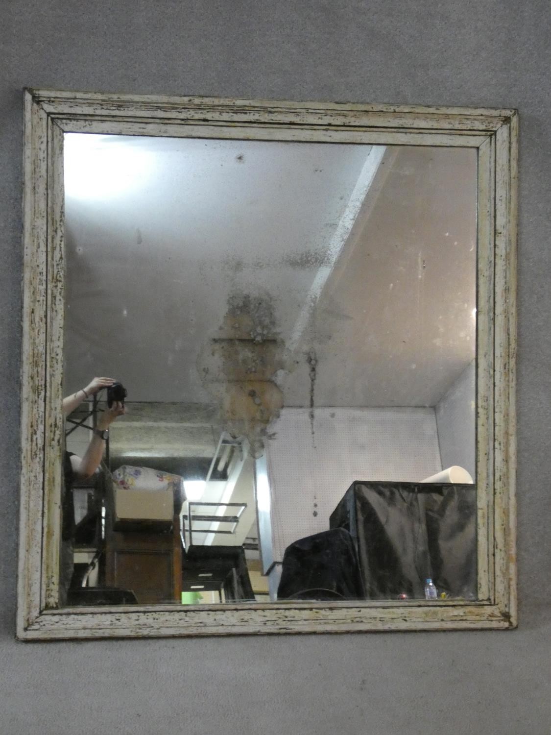 A wall mirror with original plate in distressed painted frame. 130x122