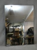 A contemporary sectional and studded wall mirror in metal frame. H.136 W.100cm