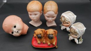 Two Dutch hand painted ceramic girl in headscarf vases along with three porcelain doll's heads and a
