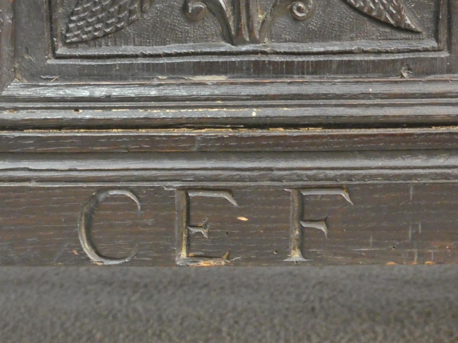 An antique country oak coffer with hinged lid above floral carved panels on block feet. H.75 L.136 - Image 7 of 8