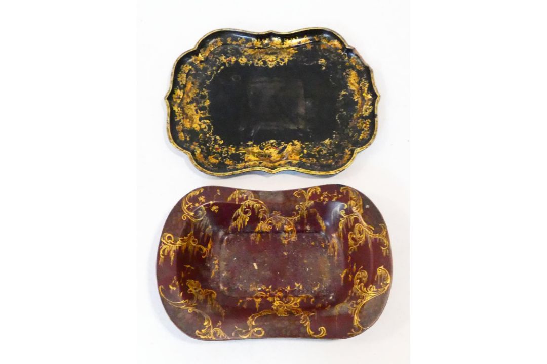 A 19th century black lacquered papier mache tray with gilt floral painted decoration and a similar