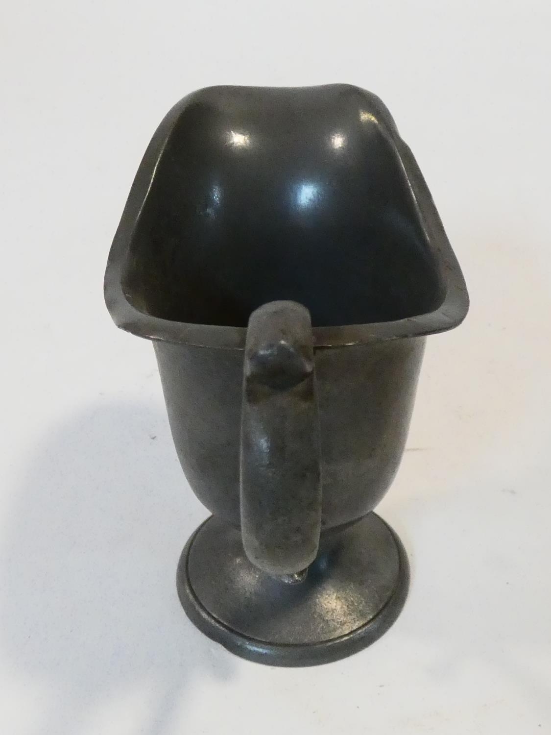 A collection of antique pewter items. Including plates, measures, pepper shaker, jug and tankards. - Image 16 of 27