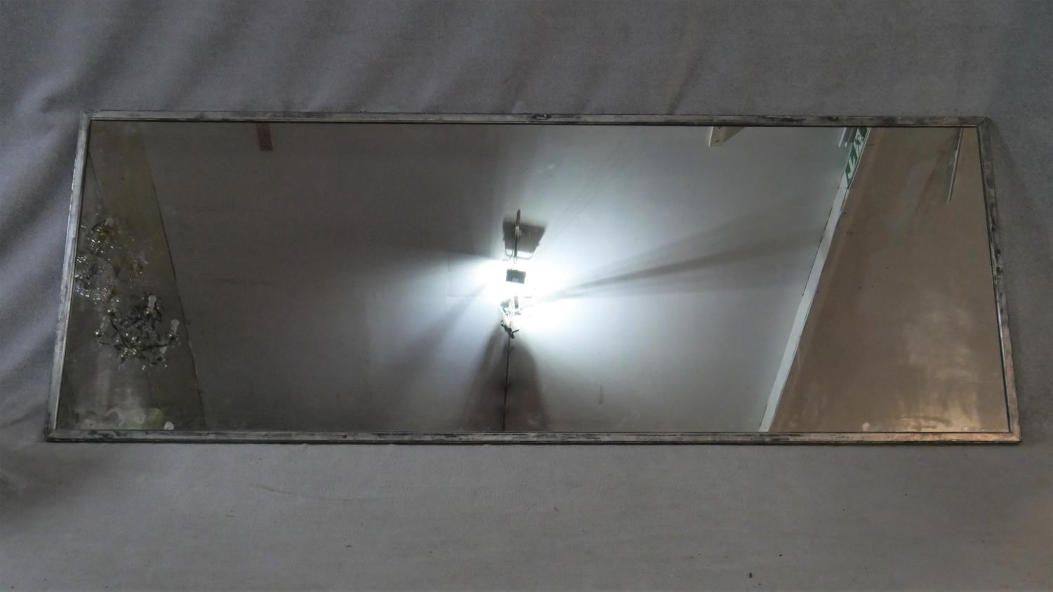 A very large vintage studio mirror in distressed painted metal frame. H.109 W.299cm