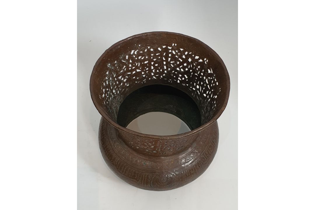 An Islamic copper pierced and repousse work lamp cover with a stylised calligraphic patterning. H. - Image 3 of 4