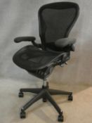 A contemporary Herman Miller ergonomic design tilting and swivelling Aeron office desk chair, size
