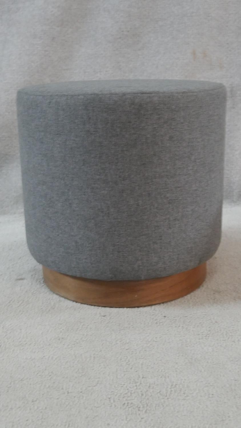 A pair of cylindrical stools upholstered in grey calico on cherrywood plinth bases. H.39cm - Image 2 of 3
