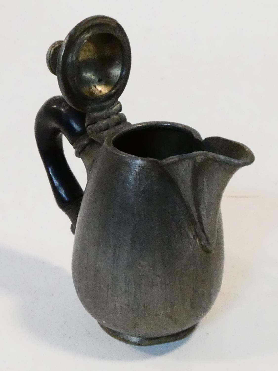 A collection of antique pewter items. Including plates, measures, pepper shaker, jug and tankards. - Image 24 of 27