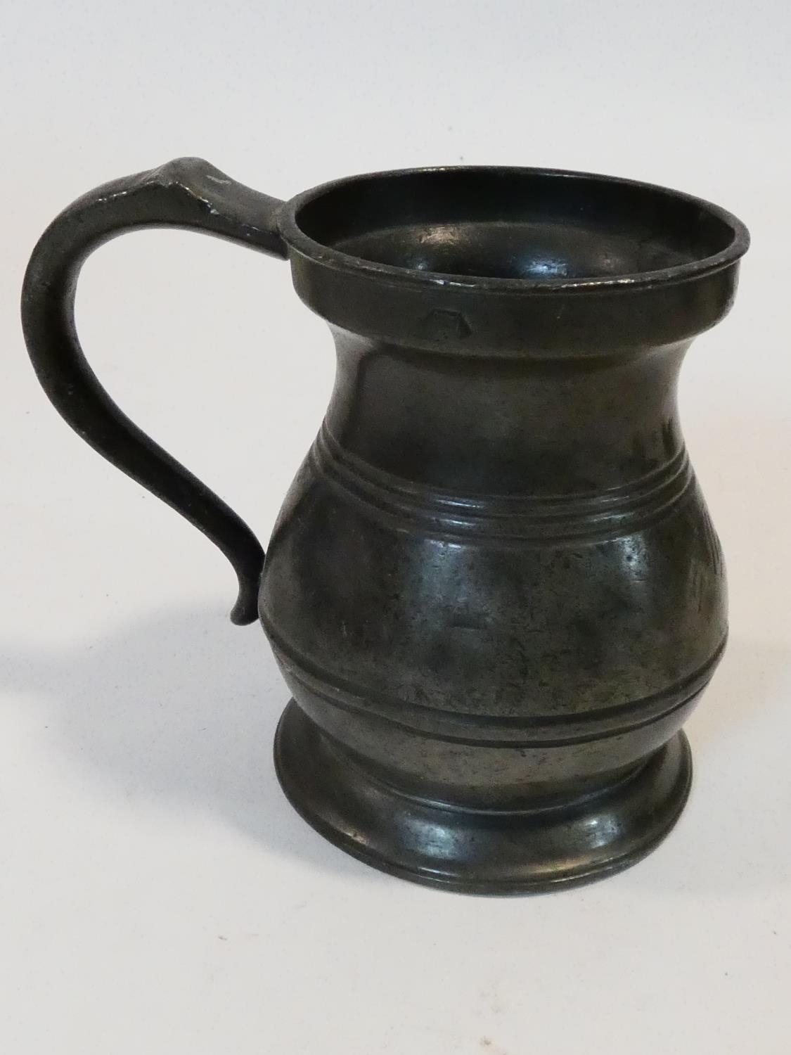 A collection of antique pewter items. Including plates, measures, pepper shaker, jug and tankards. - Image 10 of 27