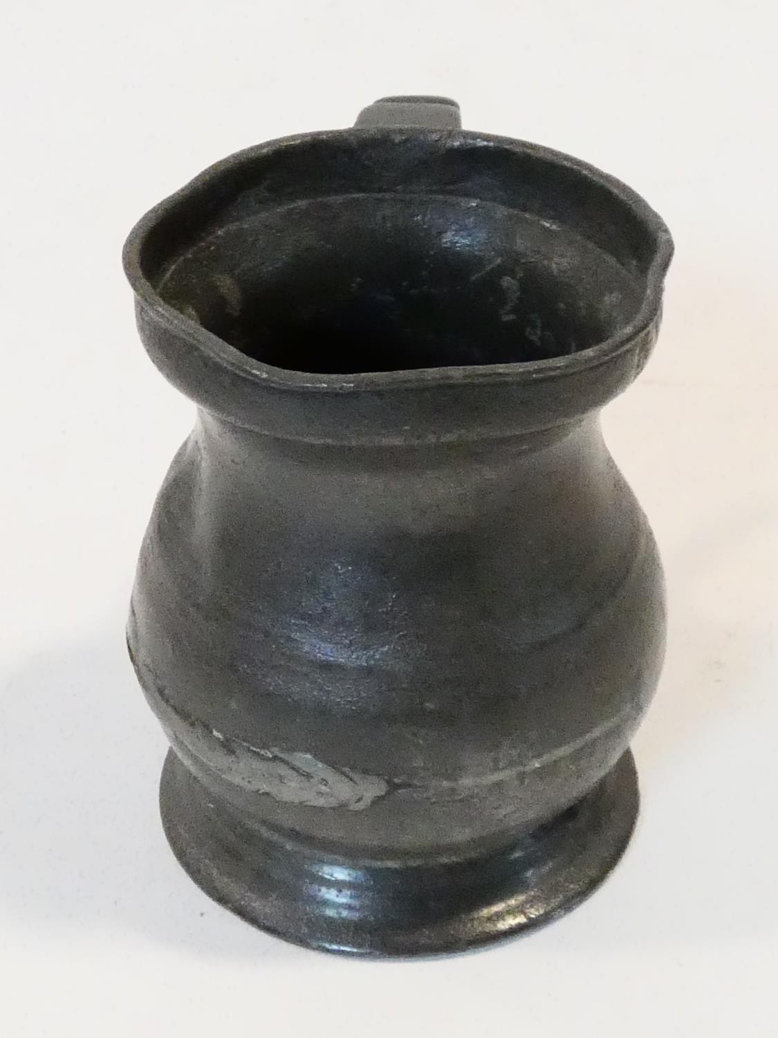 A collection of antique pewter items. Including plates, measures, pepper shaker, jug and tankards. - Image 19 of 27