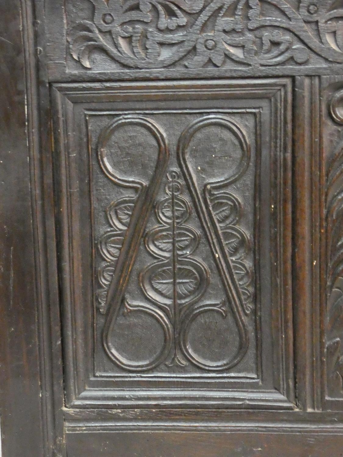 An antique country oak coffer with hinged lid above floral carved panels on block feet. H.75 L.136 - Image 4 of 8