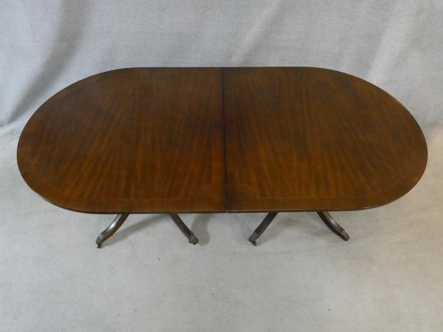 A Regency style mahogany and satinwood strung twin pillar dining table on swept quadruped supports - Image 2 of 6
