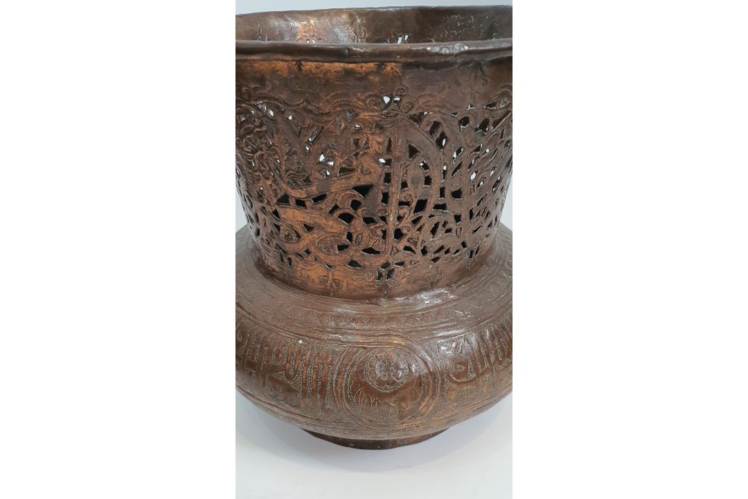 An Islamic copper pierced and repousse work lamp cover with a stylised calligraphic patterning. H. - Image 2 of 4