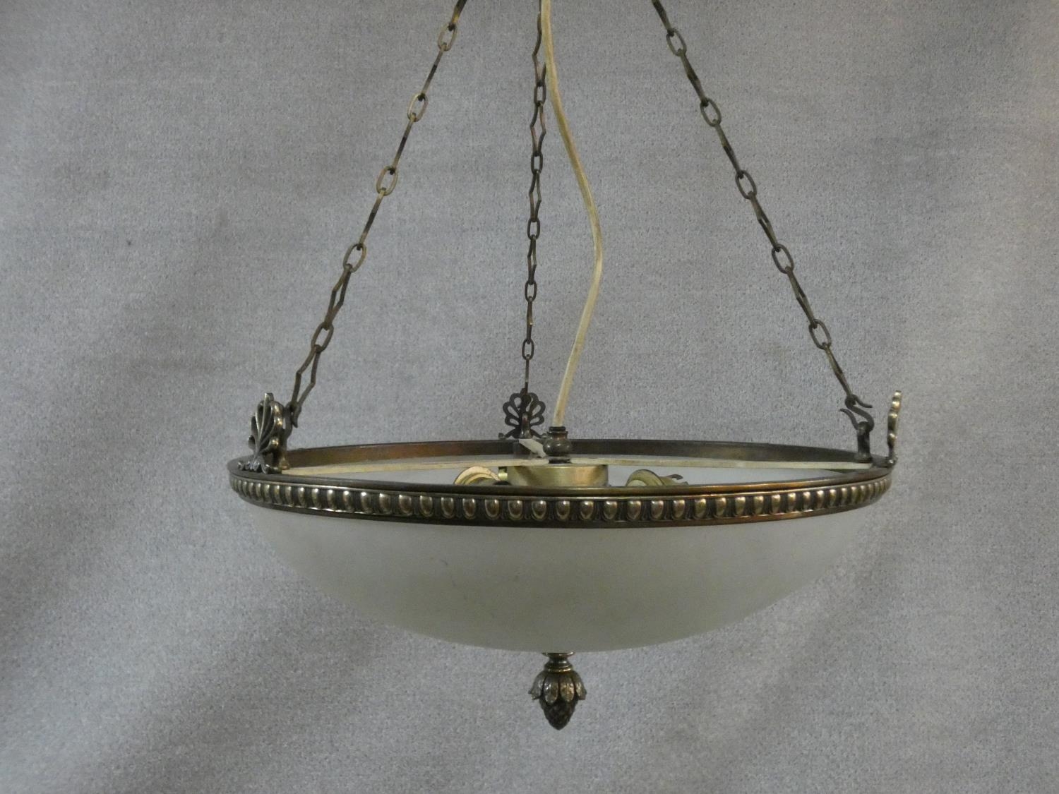 A vintage bronze ceiling pendant with frosted domed glass shade with central pineapple finial. D.