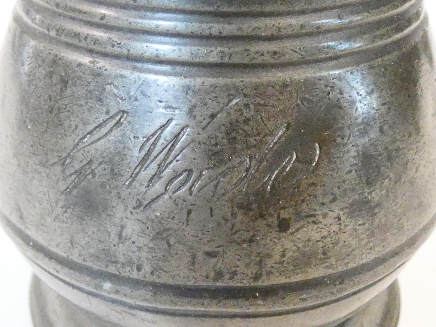 A collection of antique pewter items. Including plates, measures, pepper shaker, jug and tankards. - Image 13 of 27