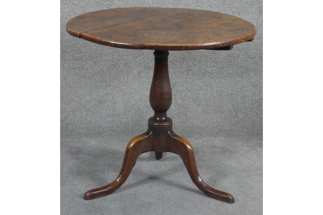 A Georgian oak tilt top table on baluster pedestal tripod supports. H.75cm (top in need of some - Image 1 of 4