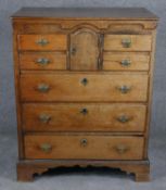 A Georgian country oak chest of drawers with shaped frieze and apron and an arrangement of cupboards