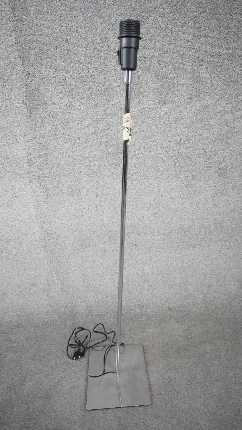 A contemporary chrome adjustable standard lamp on rectangular polished chrome base. H.116