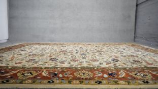 An Indian Agra on wool pile rug with tree of life motifs on a cream ground. H.196 W.321