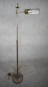 A vintage solid brass height adjustable swing arm floor lamp with triangular shade and circular