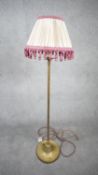 A vintage solid brass weighted base height adjustable standard lamp with silk wrapped cord and