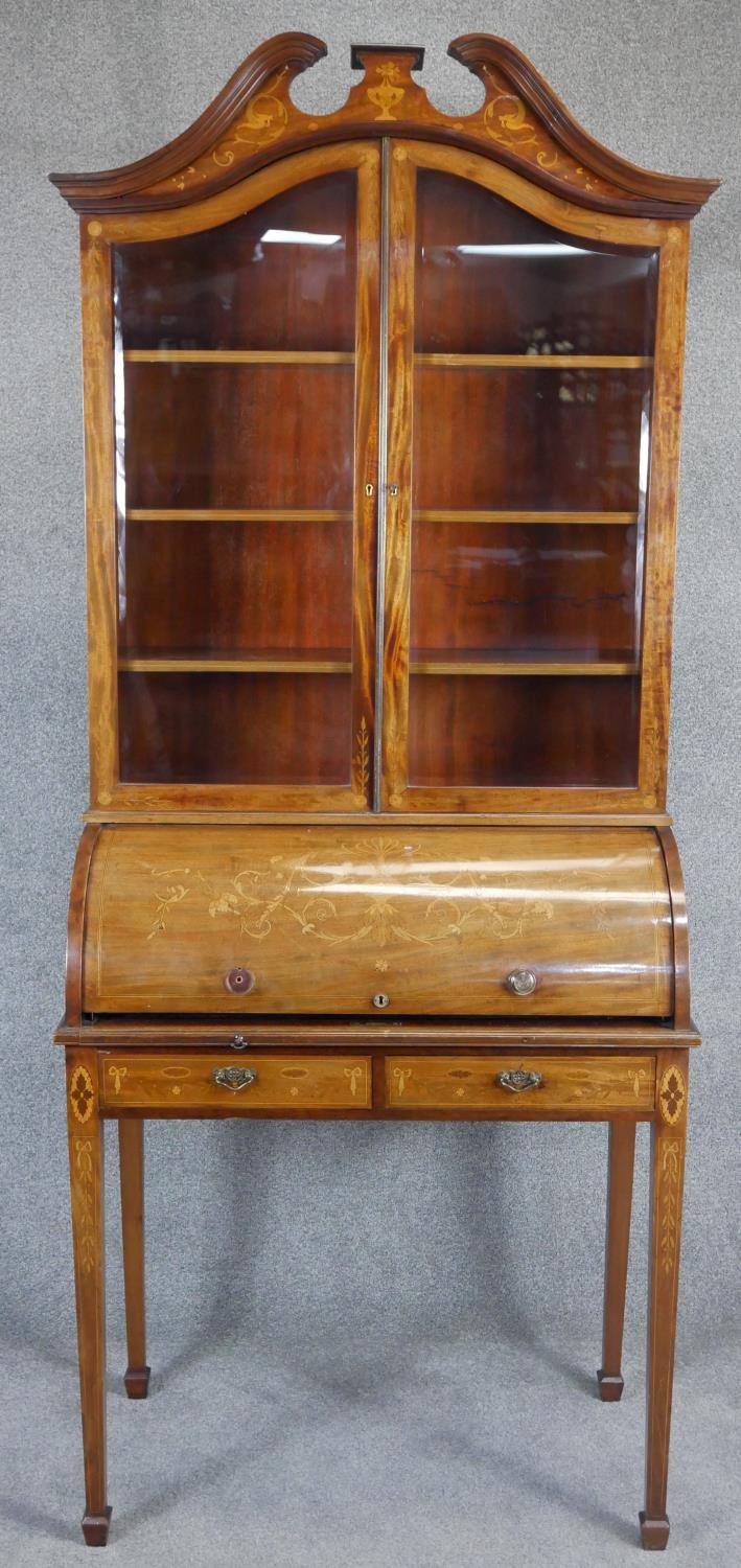An Edwardian mahogany cylinder bureau bookcase with profuse all over satinwood Ho Ho bird, dragon,