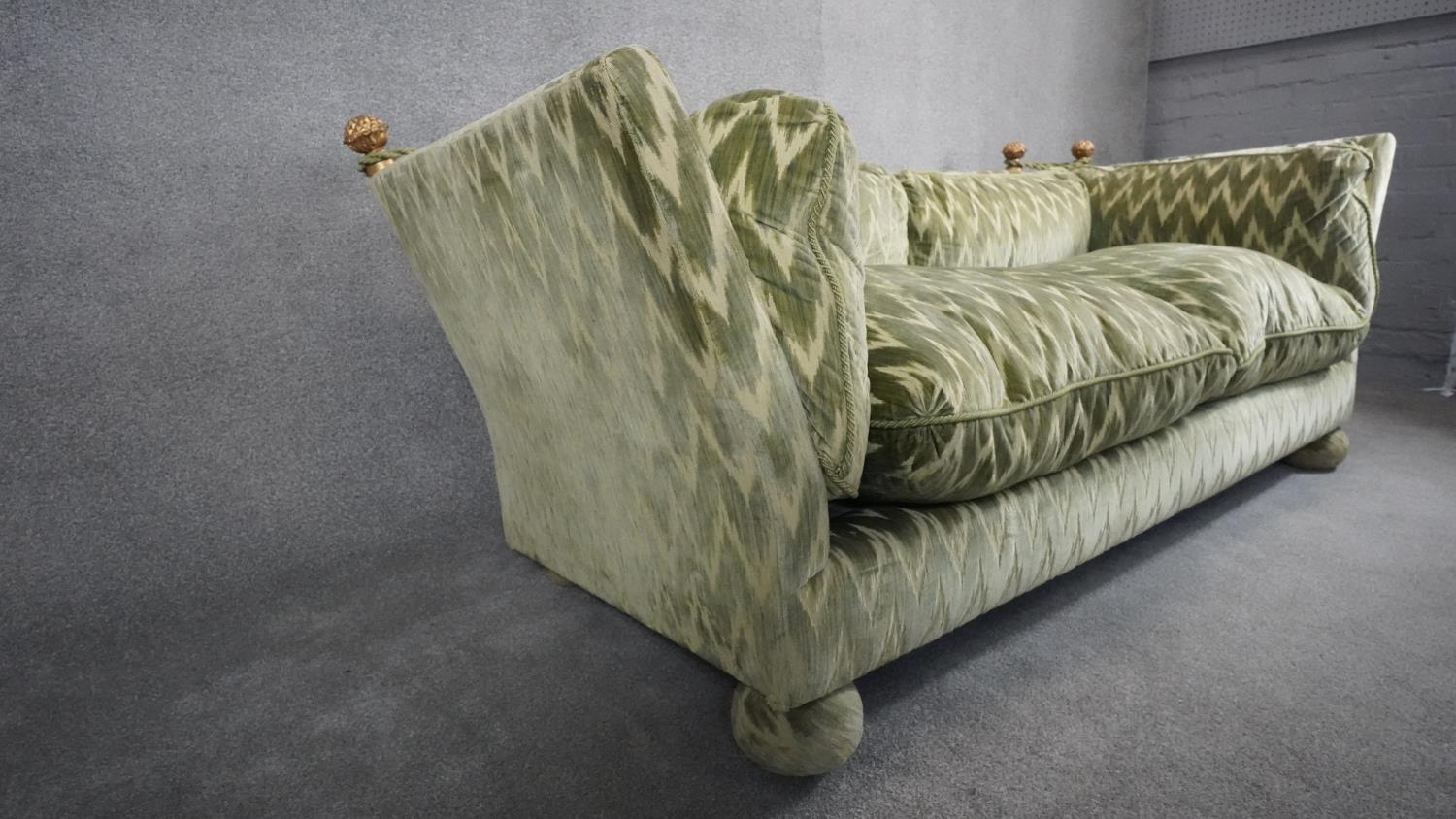 A Knole sofa in cut velour upholstery the drop ends with carved giltwood finials raised on bun feet. - Image 3 of 7
