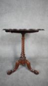 A mid Victorian walnut chess table with satinwood floral inlaid top on spiral twist pedestal resting
