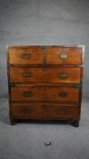 A 19th century camphorwood two part brass bound military chest with brass inset handles and twin