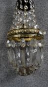 A cut crystal and brass chandelier. With a brass chain fitting. D.15cm