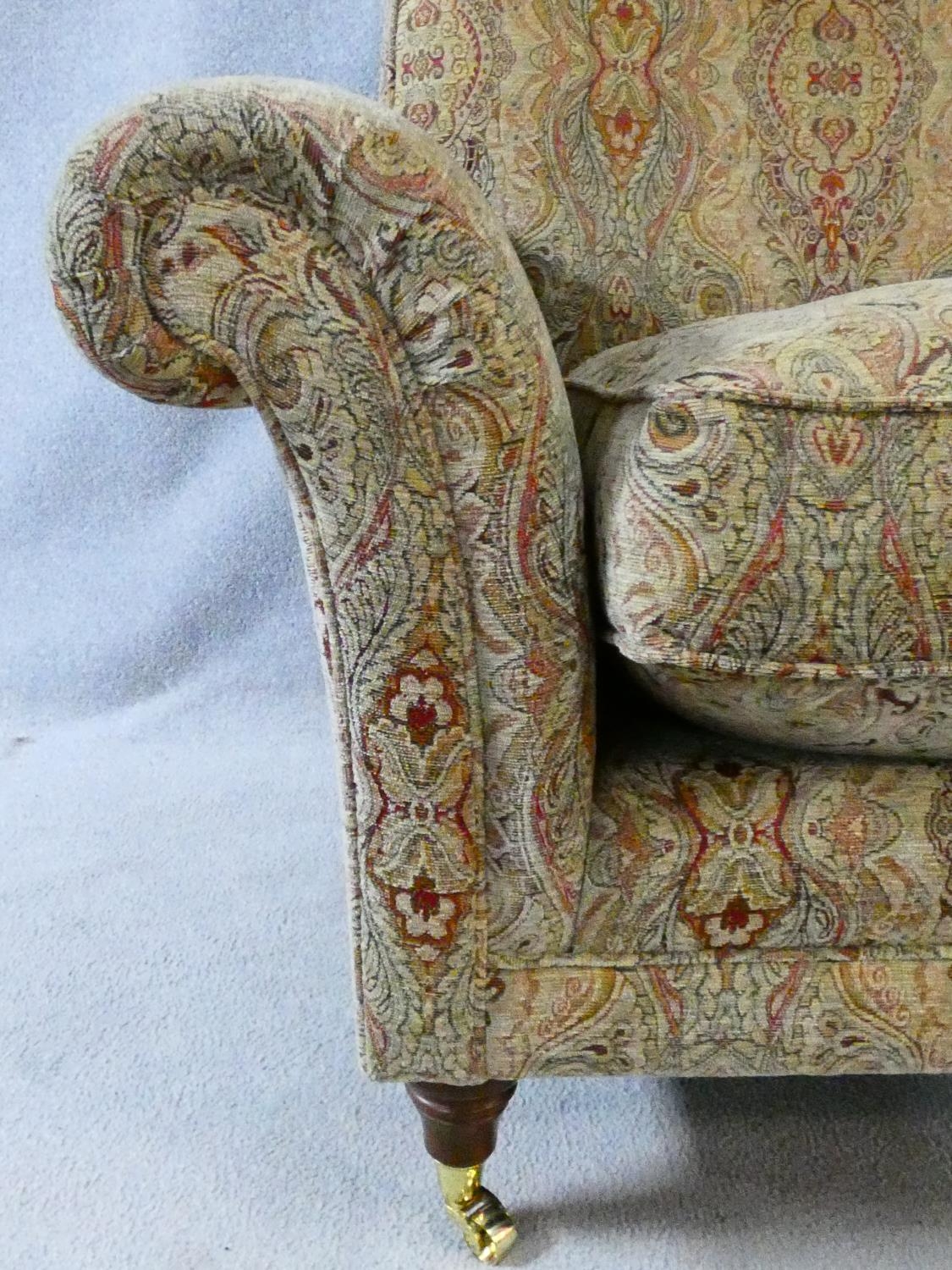 A Parker Knoll Burghley armchair in Baslow Medalli gold upholstery raised on turned tapering - Image 4 of 6