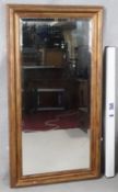 A gilt framed dressing mirror with bevelled plate. H.131 W.69cm