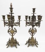 A pair of antique style cast brass five branch candelabras with floral and bird design. With flame