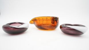 A collection of three vintage Murano style glass bowls. One in amber glass with a stylised leaf
