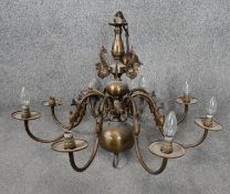 A Dutch style bronze effect brass eight branch chandelier with dolphin motifs. D.84cm