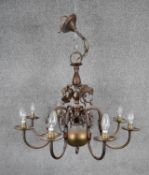 A Baroque style bronze effect brass eight branch chandelier with dolphin motifs. D.70cm