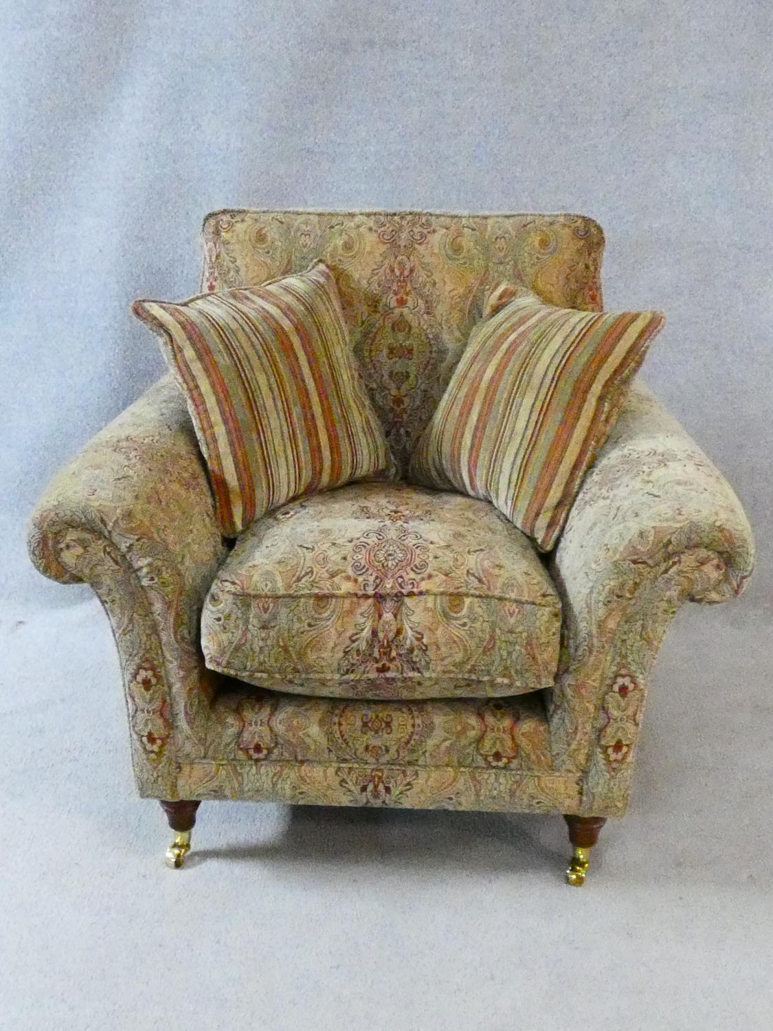 A Parker Knoll Burghley armchair in Baslow Medalli gold upholstery raised on turned tapering - Image 2 of 6