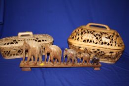 A CARVED WOODEN ELEPHANT TRAIN AND TWO CARVED WOODEN LIDDED BASKETS