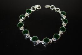A STERLING SILVER AND GREEN STONE BRACELET