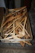 A QUANTITY OF WOODEN COAT HANGERS