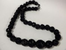 A CARVED WHITBY JET BEADED NECKLACE