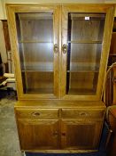 AN ERCOL WINSOR GLAZED BOOKCASE WITH TWO DRAWERS AND CUPBOARDS BELOW H-160 W-91 CM