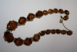 A VINTAGE TIGERS EYE STYLE AGATE NECKLACE, in a gilt mount
